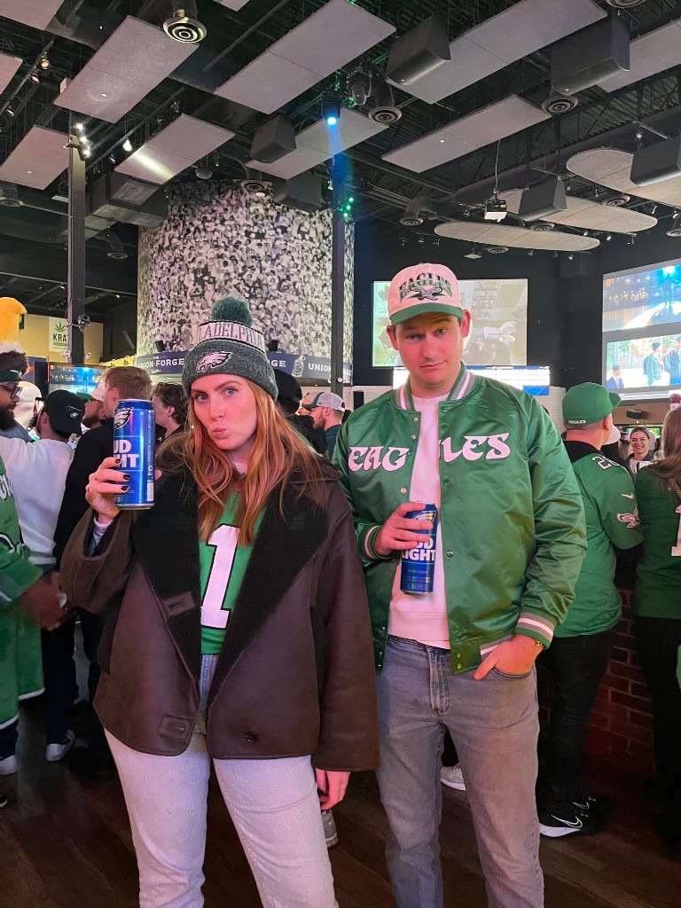Laura and Andrew in Eagles gear at a sports bar