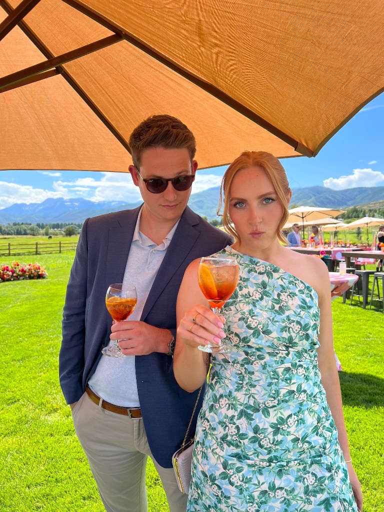 Laura and Andrew with cocktails at an outdoor garden party